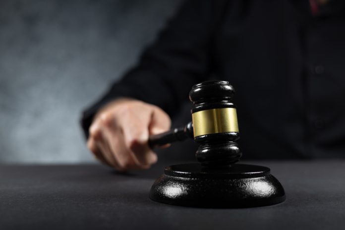 Judge,Hitting,Gavel,Off,A,Block,In,Courtroom,,Law,And